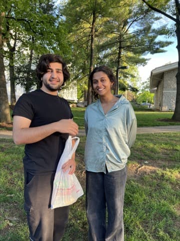 Couple walking through a park with grocery bags